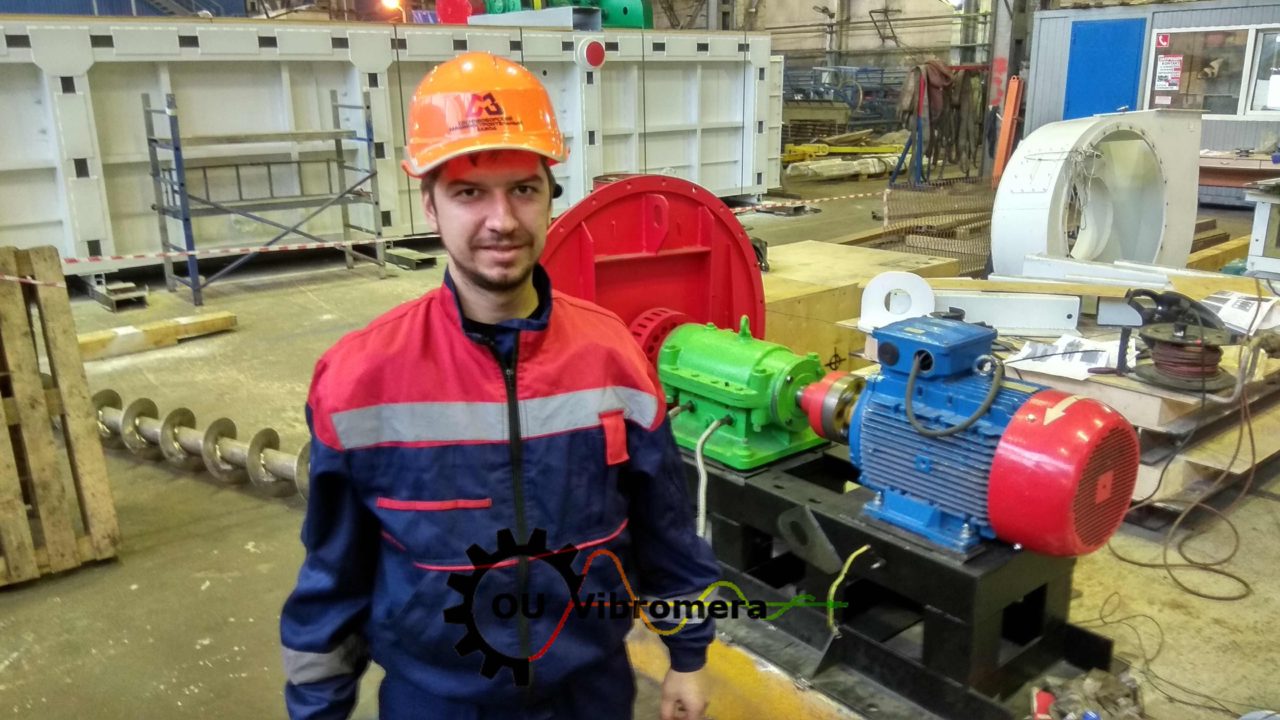 Technician performing on-site balancing on a large industrial fan.